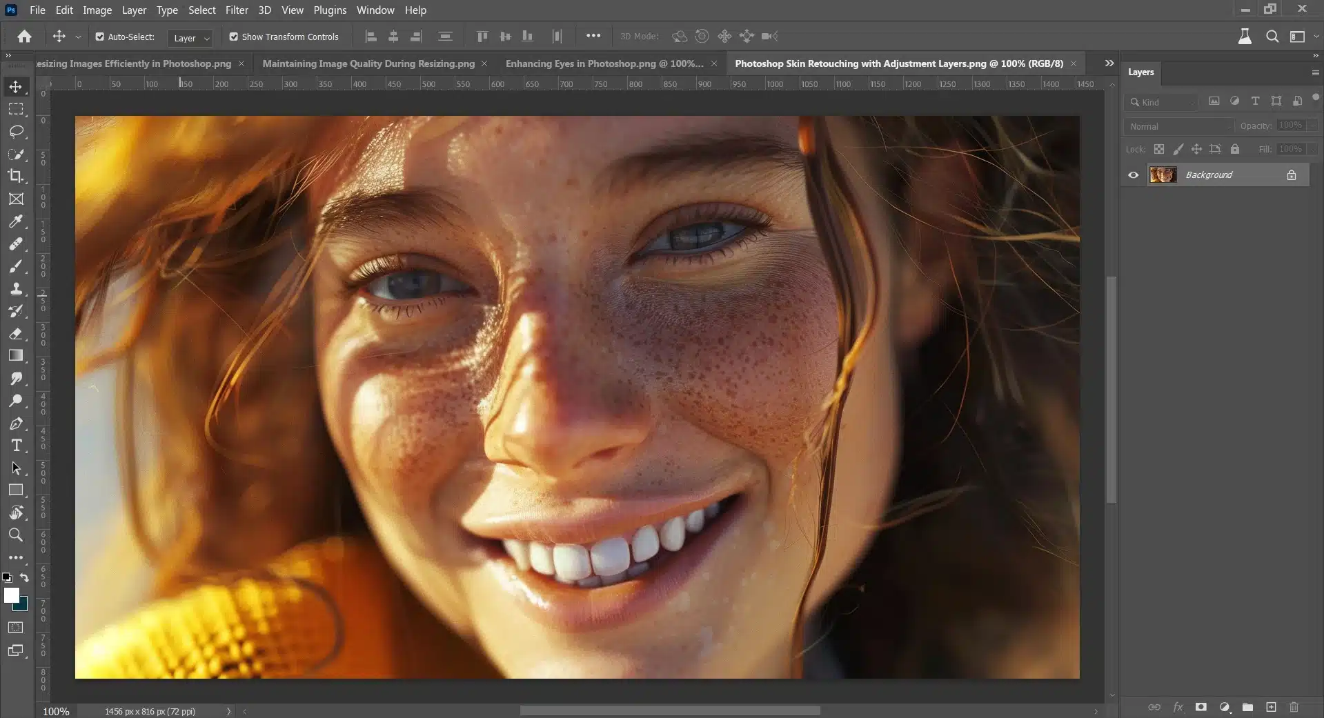 Close-up of a smiling woman's face with visible freckles being retouched in Photoshop.