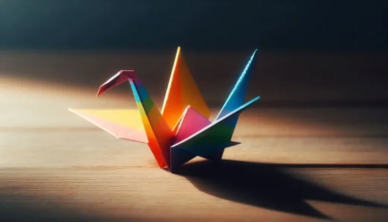 Rainbow-colored origami crane on a wooden surface with dramatic lighting and shadow.