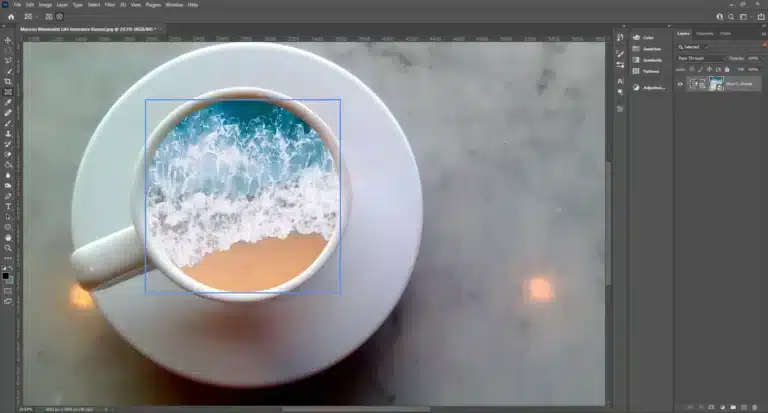 Adobe Photoshop workspace with a Frame Tool active, showing an image of a beach with waves inside a circular frame on a marble background.