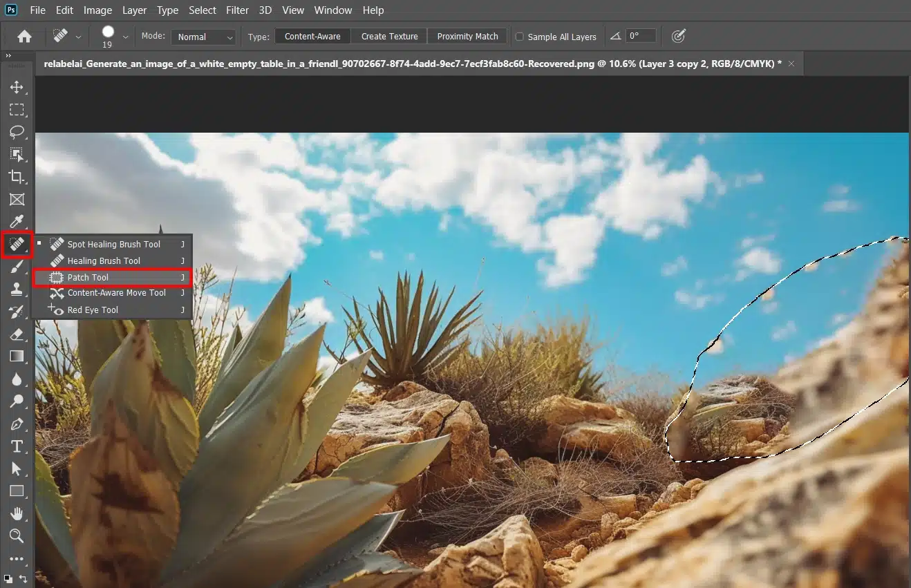 Screenshot of Photoshop's Patch Tool and other healing tools menu with a desert plant landscape in the background