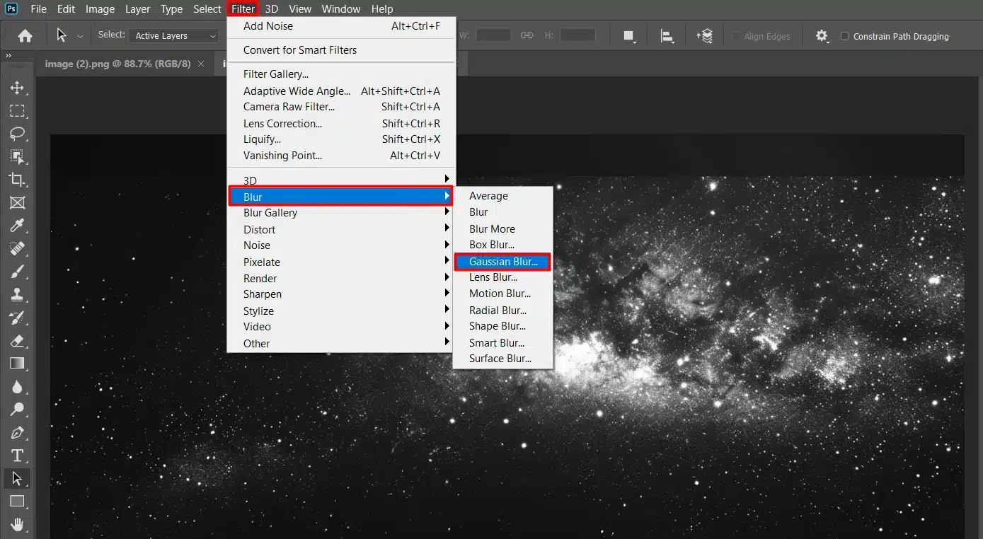Photoshop interface showing the "Gaussian Blur" filter being applied to an image of a starry night sky.