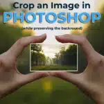 Hands holding a cropped image in a forest setting to demonstrate how to crop an image in Photoshop while preserving the background.