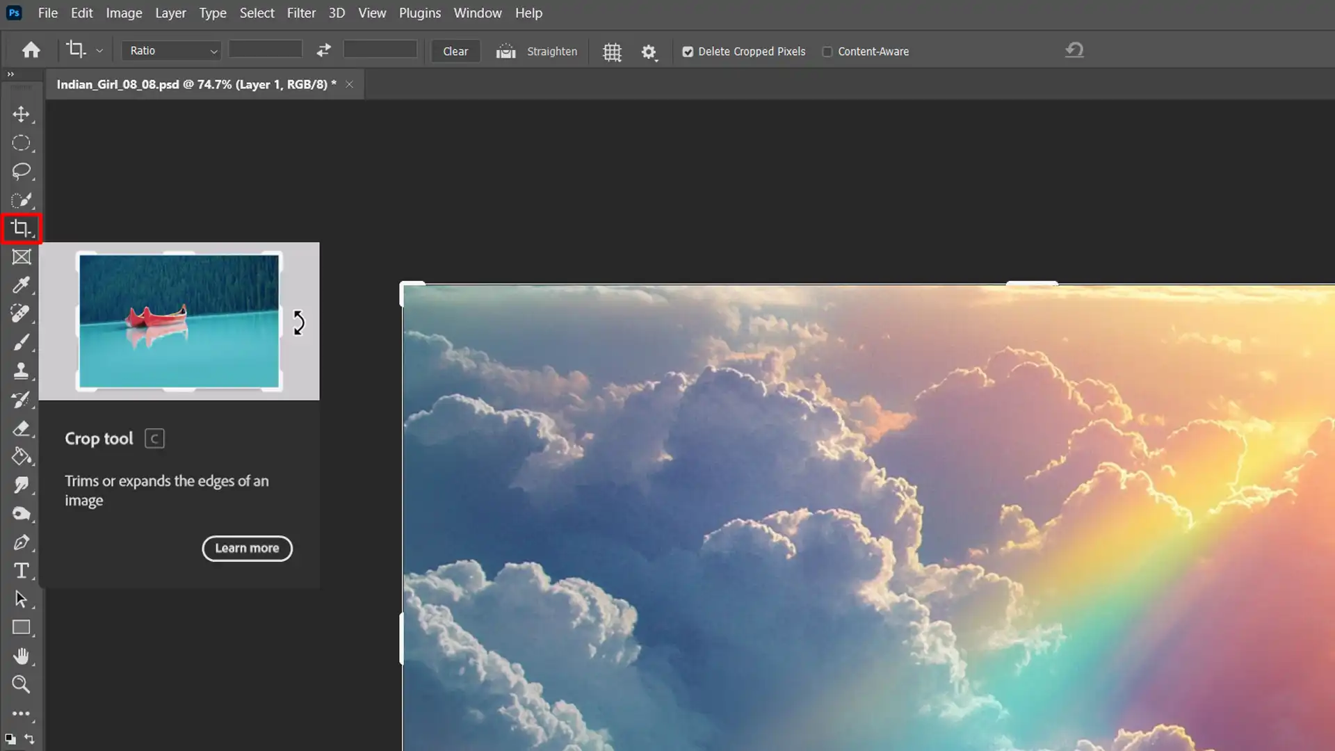 Photoshop Crop Tool interface with an image of clouds and a lake.