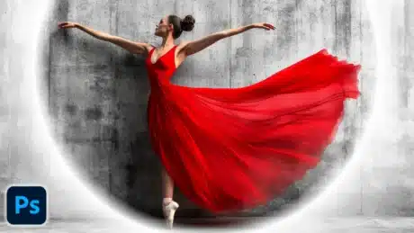 Ballerina in a flowing red dress performing in front of a textured wall with a white vignette effect added in Photoshop.