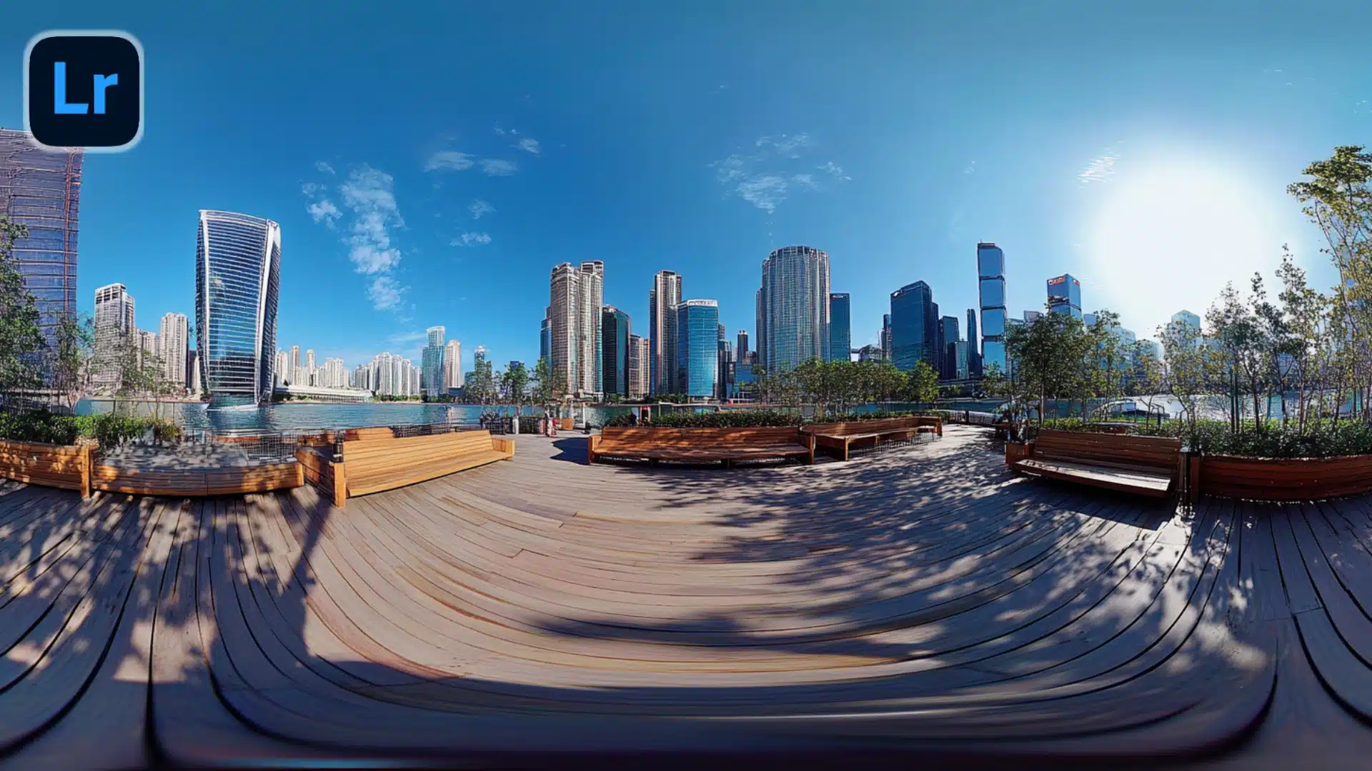 360-degree cityscape view of a modern waterfront park with skyscrapers in the background, edited in Lightroom Classic.