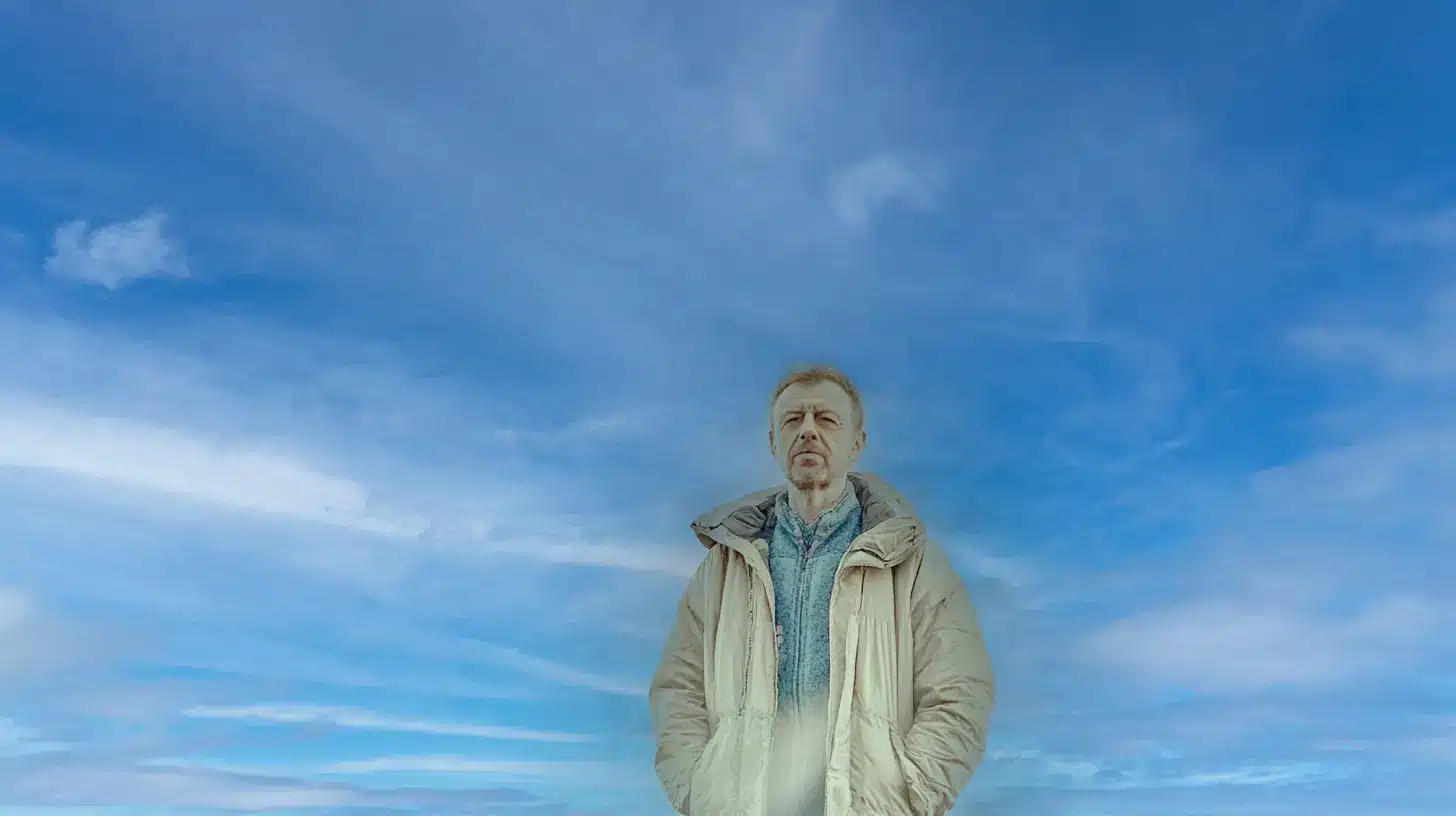 A Photoshop workspace displaying the Sky Replacement tool in use, with a person standing under a newly replaced blue sky. The Sky Replacement panel is open, showing settings like Shift Edge, Fade Edge, Brightness, and Temperature adjustments, along with various sky options.