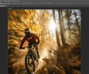 "Photoshop interface showing the application of radial blur to a photo of a cyclist, creating a motion effect by blurring the background while keeping the subject sharp.